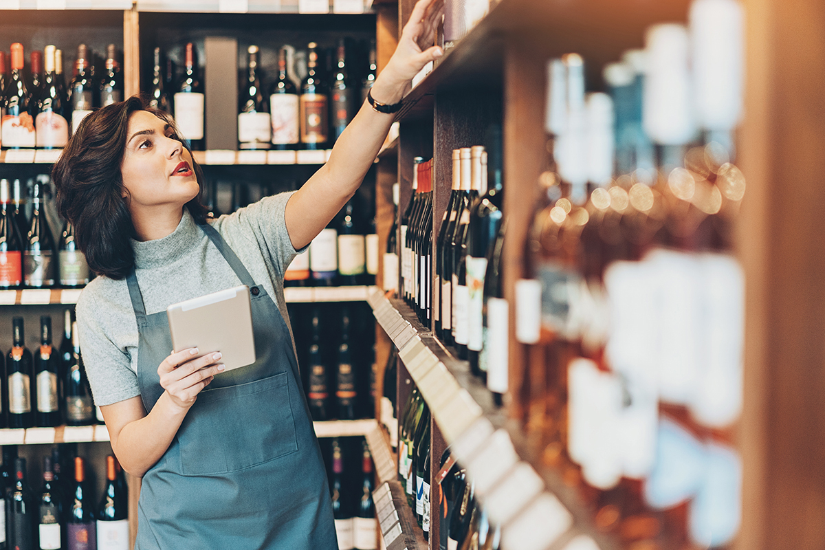 Woman looking at shelves of wine