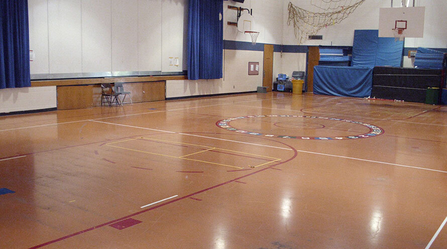 a rubberized surface basketball court at a school