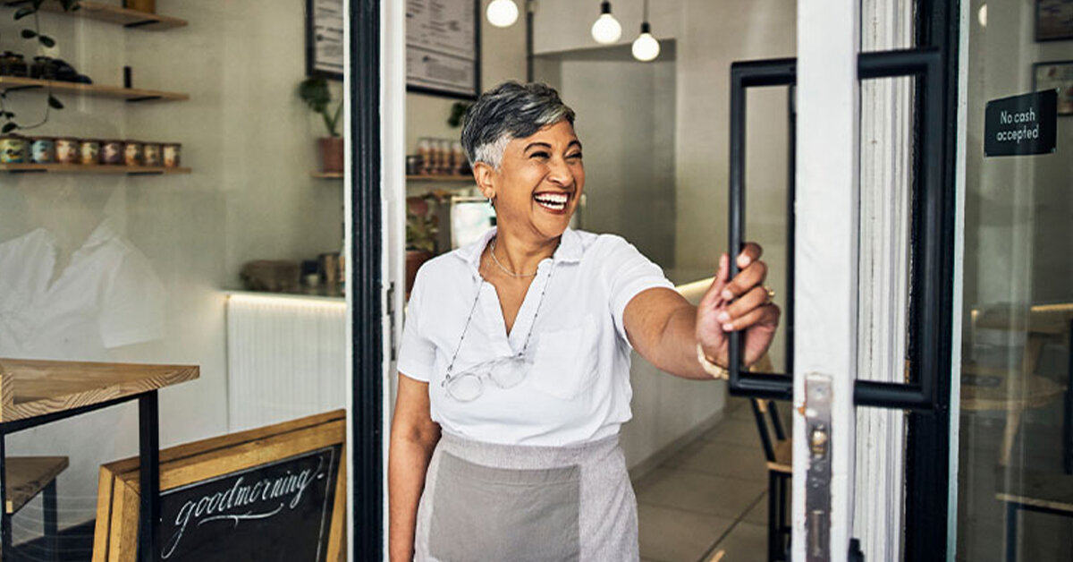 Business owner opens the door to her store
