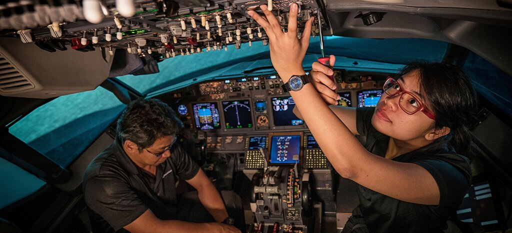 technicians working in aircraft cockpit