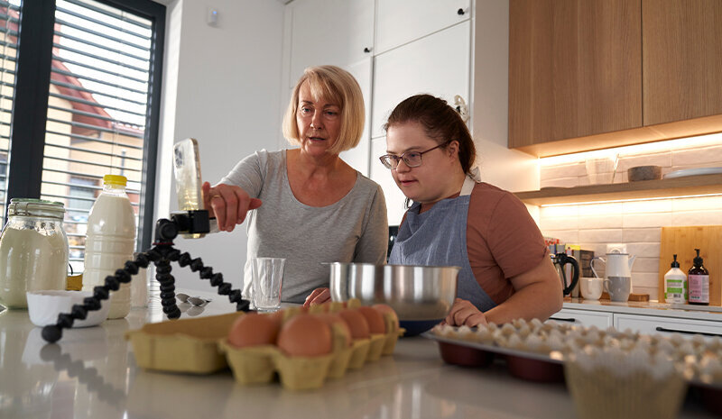 down syndrome woman baking with her mother