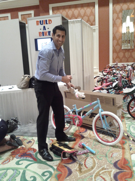 David Silverman, CEO of NFM, Inc. builds a bike for underprivileged youth.