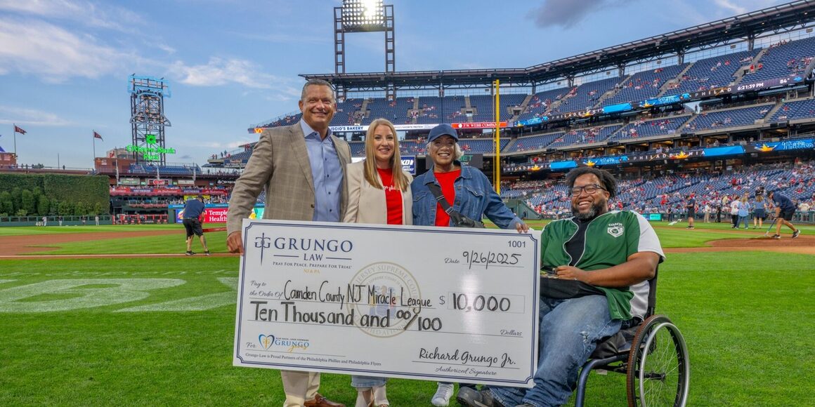 Grungo Law presents the Camden County New Jersey Miracle League with $10,000 check at Citizens Bank Park.