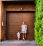 home owners in front of garage door