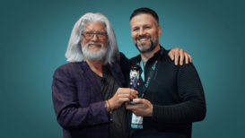LEXRA Executive Director Bob Cooney Awards VR Bobble Award to Dave Myers at VR Arcade Summit in 2022