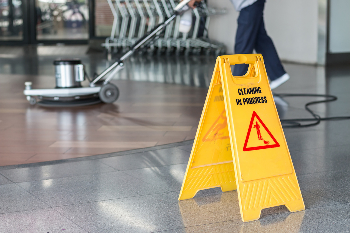 Professional commercial floor cleaning in progress at a business facility